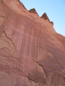 A vertical cliff wall in Paria Canyon, seen from below